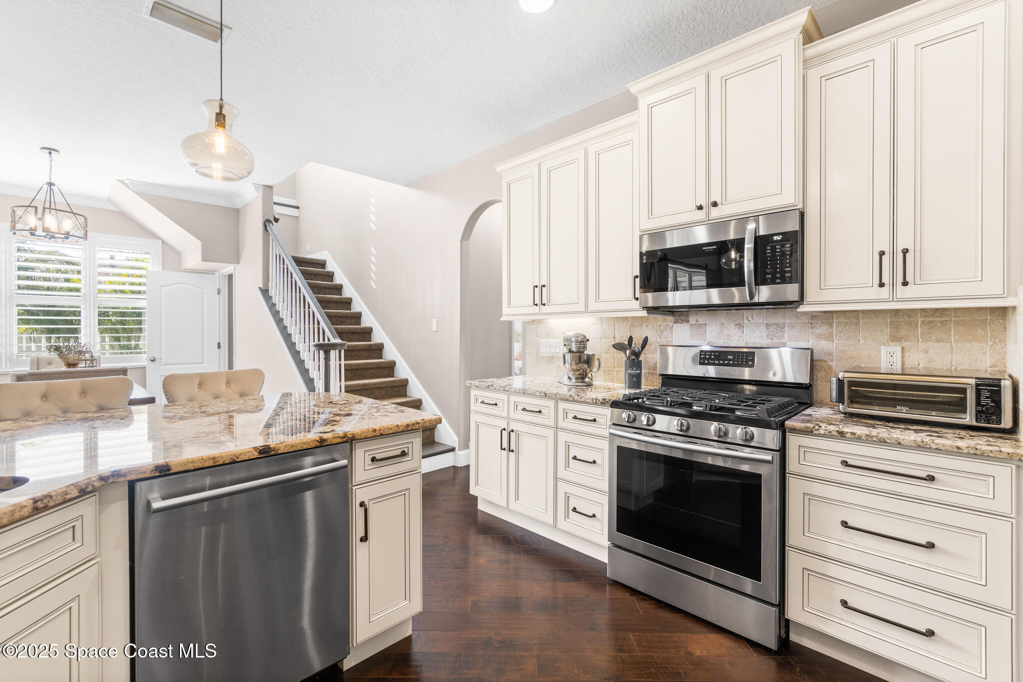 1007 Dowitcher Court Rockledge, FL 32955 - Photo 29 of 106 a kitchen with stainless steel appliances granite countertop a stove and a sink