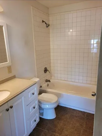 a bathroom with a sink a toilet and bathtub