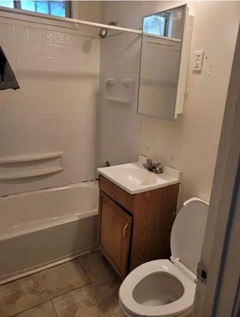 a bathroom with a toilet a sink and bathtub