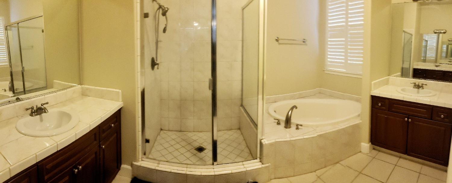 2529 Maine Avenue Clovis, CA 93619 - Photo 11 of 11 a bathroom with a tub sink and mirror