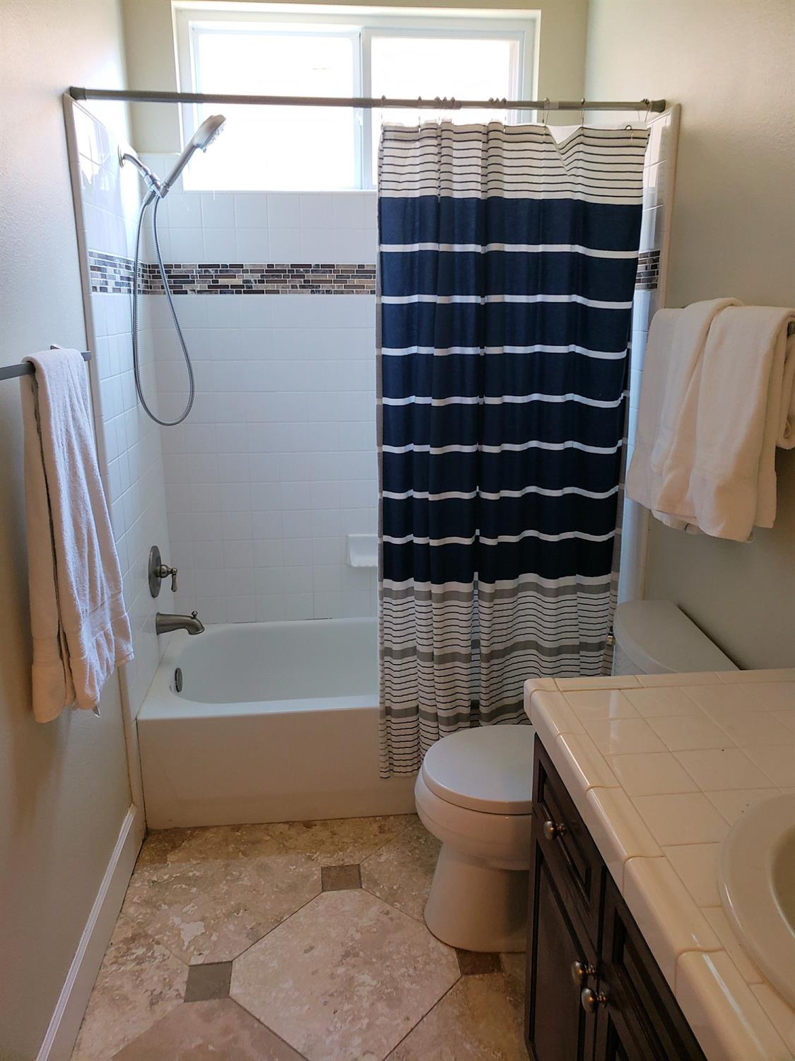 2529 Maine Avenue Clovis, CA 93619 - Photo 10 of 11 a bathroom with a sink a toilet and shower