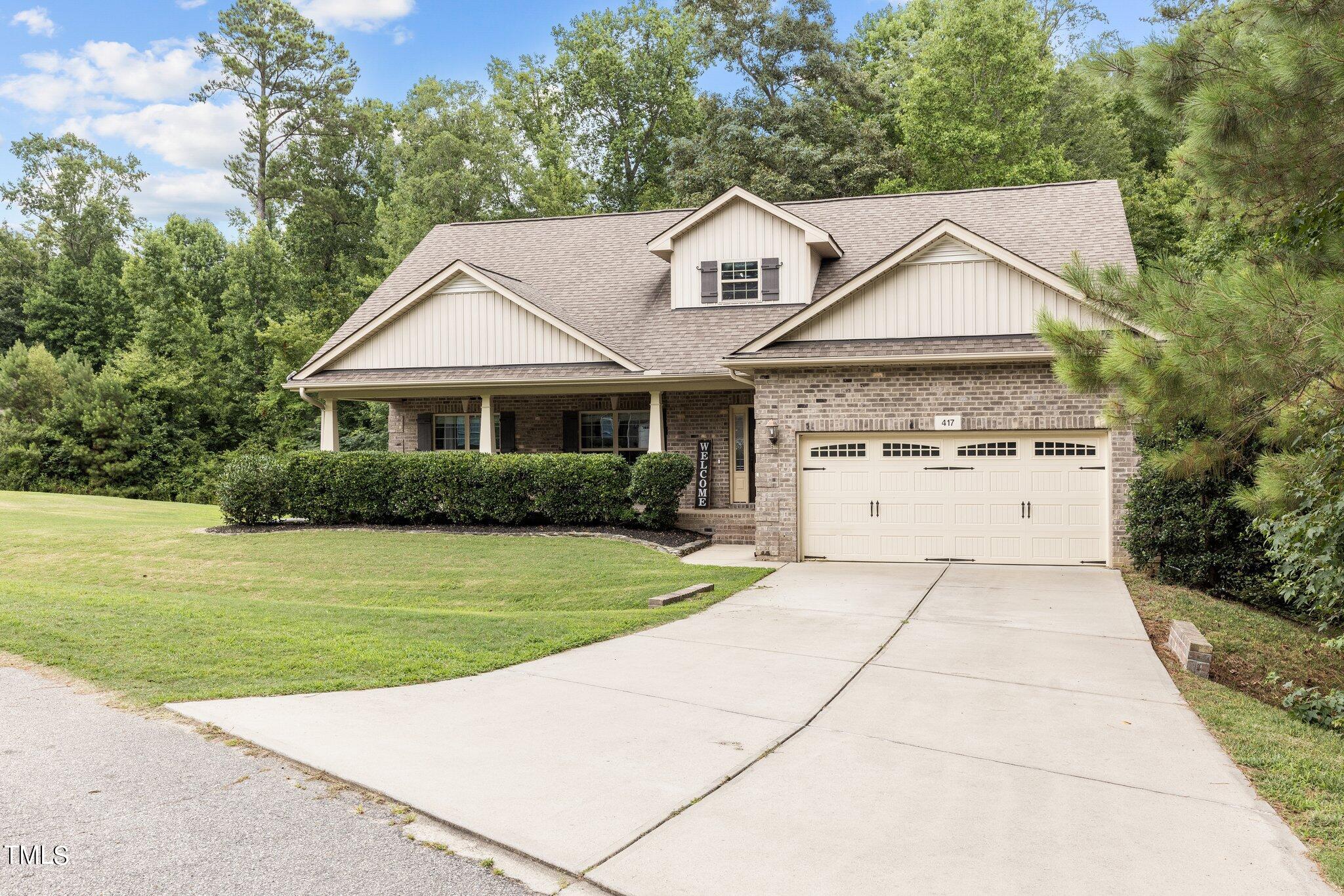 417 Bryerstone Drive Willow Spring, NC 27592 - Photo 1 of 43 a front view of a house with a garden