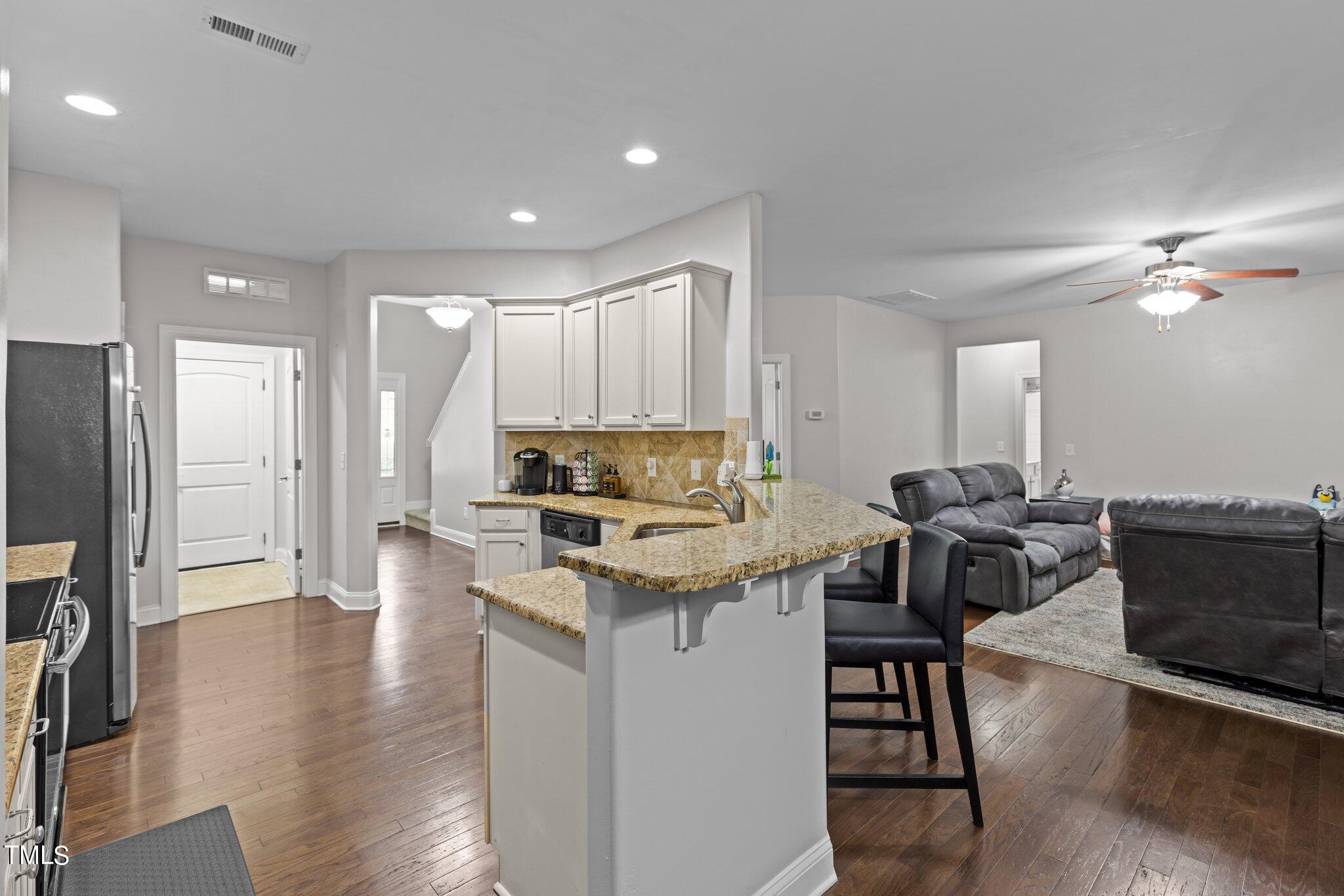 417 Bryerstone Drive Willow Spring, NC 27592 - Photo 10 of 43 a kitchen with a table chairs refrigerator and cabinets