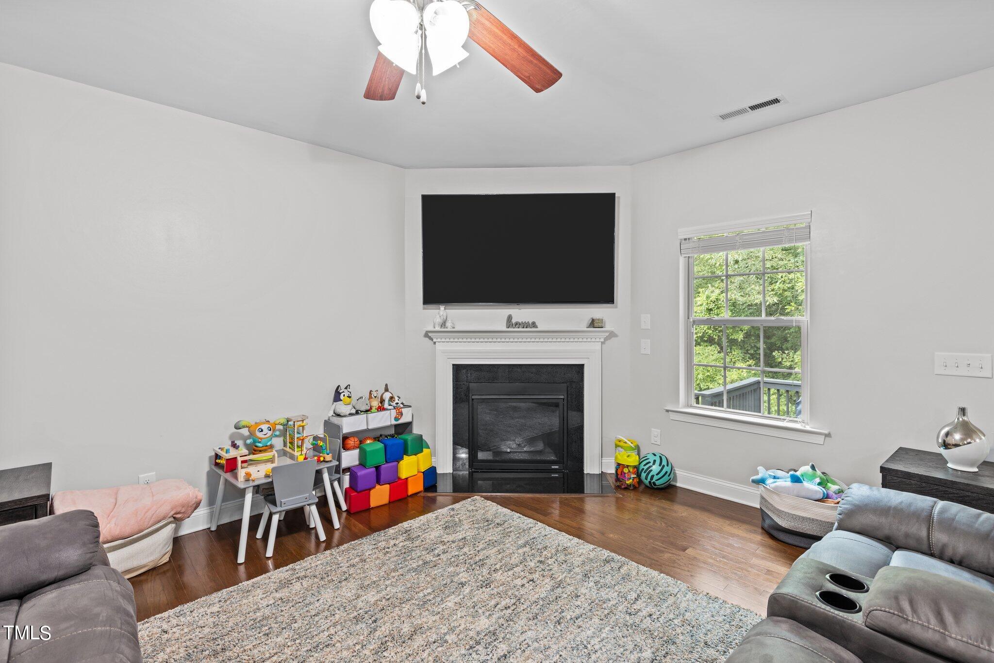 417 Bryerstone Drive Willow Spring, NC 27592 - Photo 13 of 43 a living room with furniture and a flat screen tv