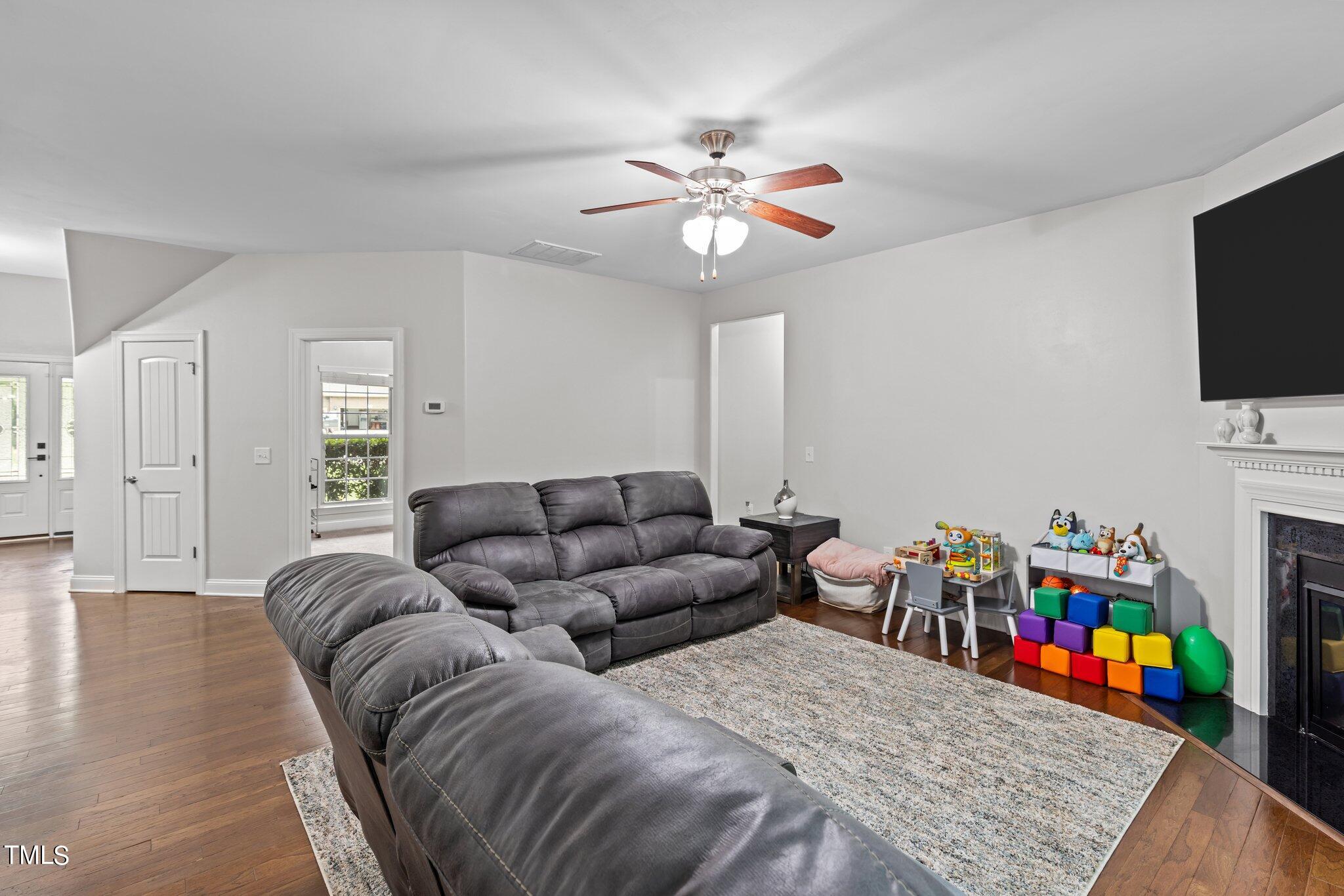 417 Bryerstone Drive Willow Spring, NC 27592 - Photo 14 of 43 a living room with furniture and a flat screen tv