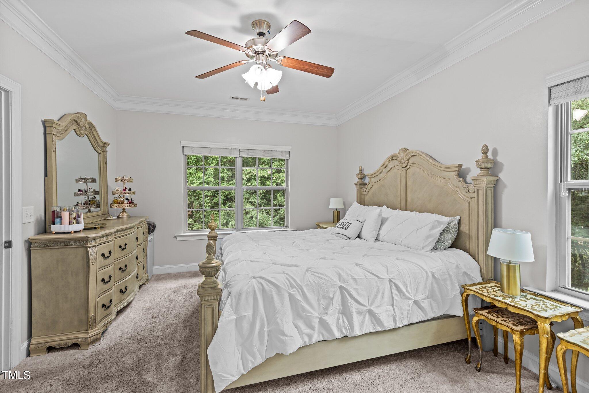 417 Bryerstone Drive Willow Spring, NC 27592 - Photo 18 of 43 a bedroom with a bed a chandelier and dresser