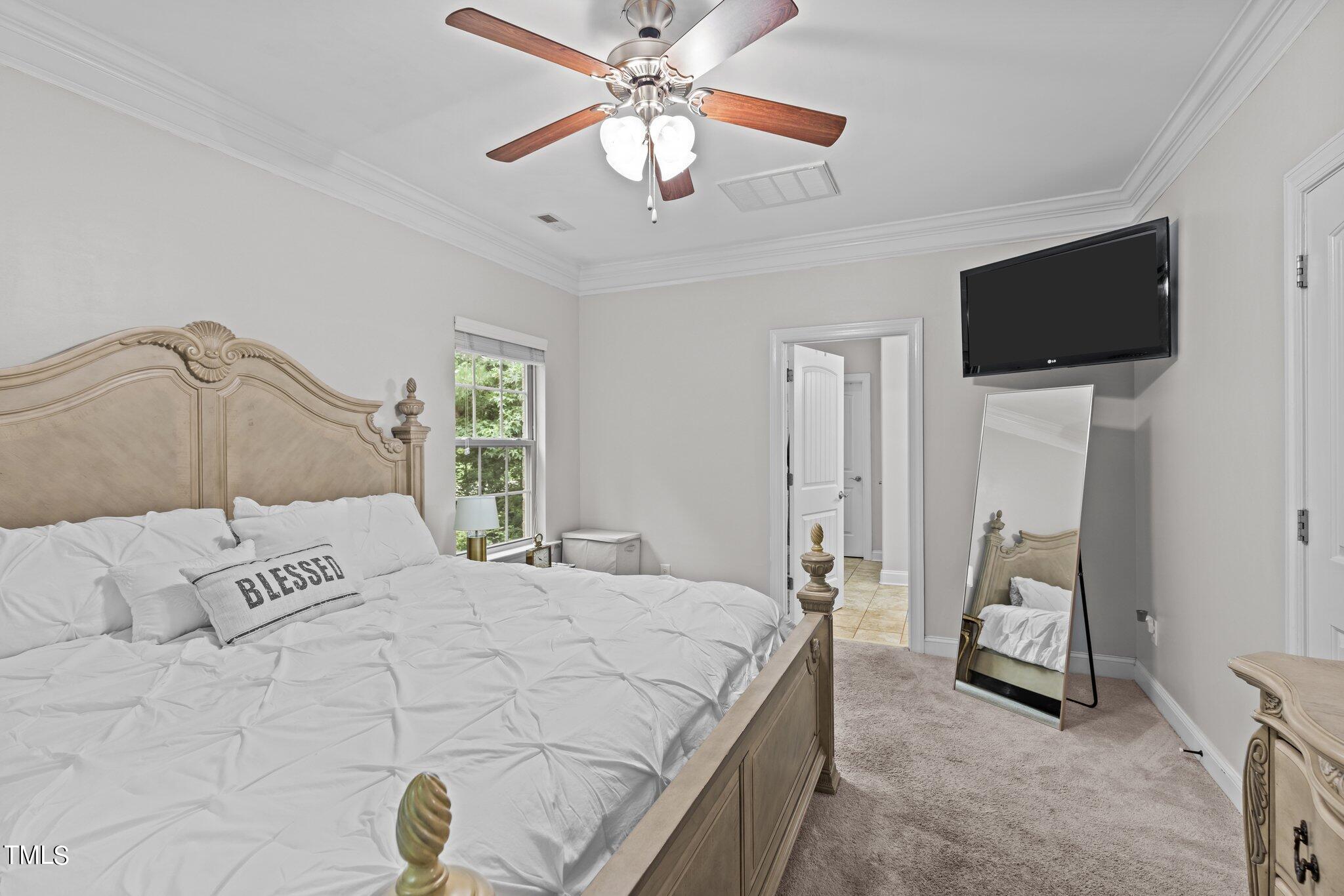 417 Bryerstone Drive Willow Spring, NC 27592 - Photo 19 of 43 a bedroom with a bed and a flat screen tv