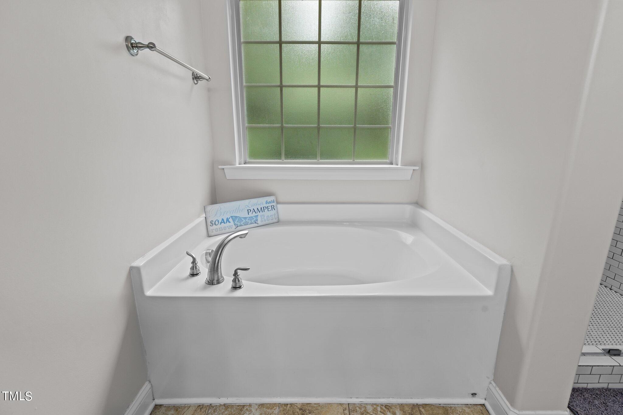 417 Bryerstone Drive Willow Spring, NC 27592 - Photo 21 of 43 a white bath tub sitting next to a window
