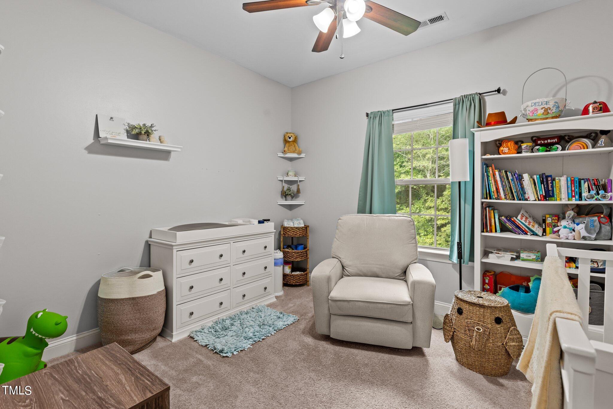 417 Bryerstone Drive Willow Spring, NC 27592 - Photo 23 of 43 a living room with furniture and book shelf