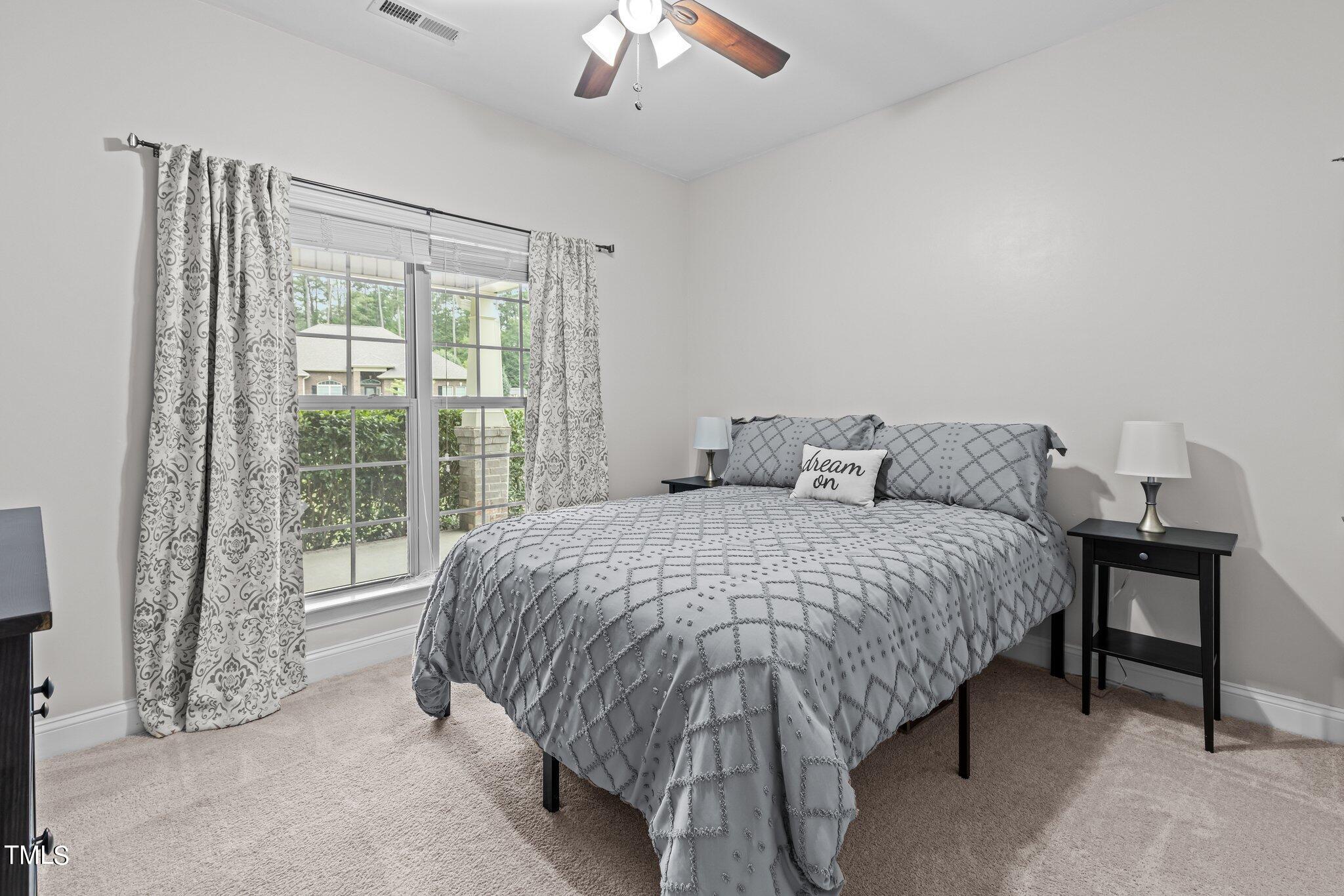 417 Bryerstone Drive Willow Spring, NC 27592 - Photo 25 of 43 a bedroom with a bed and a large window