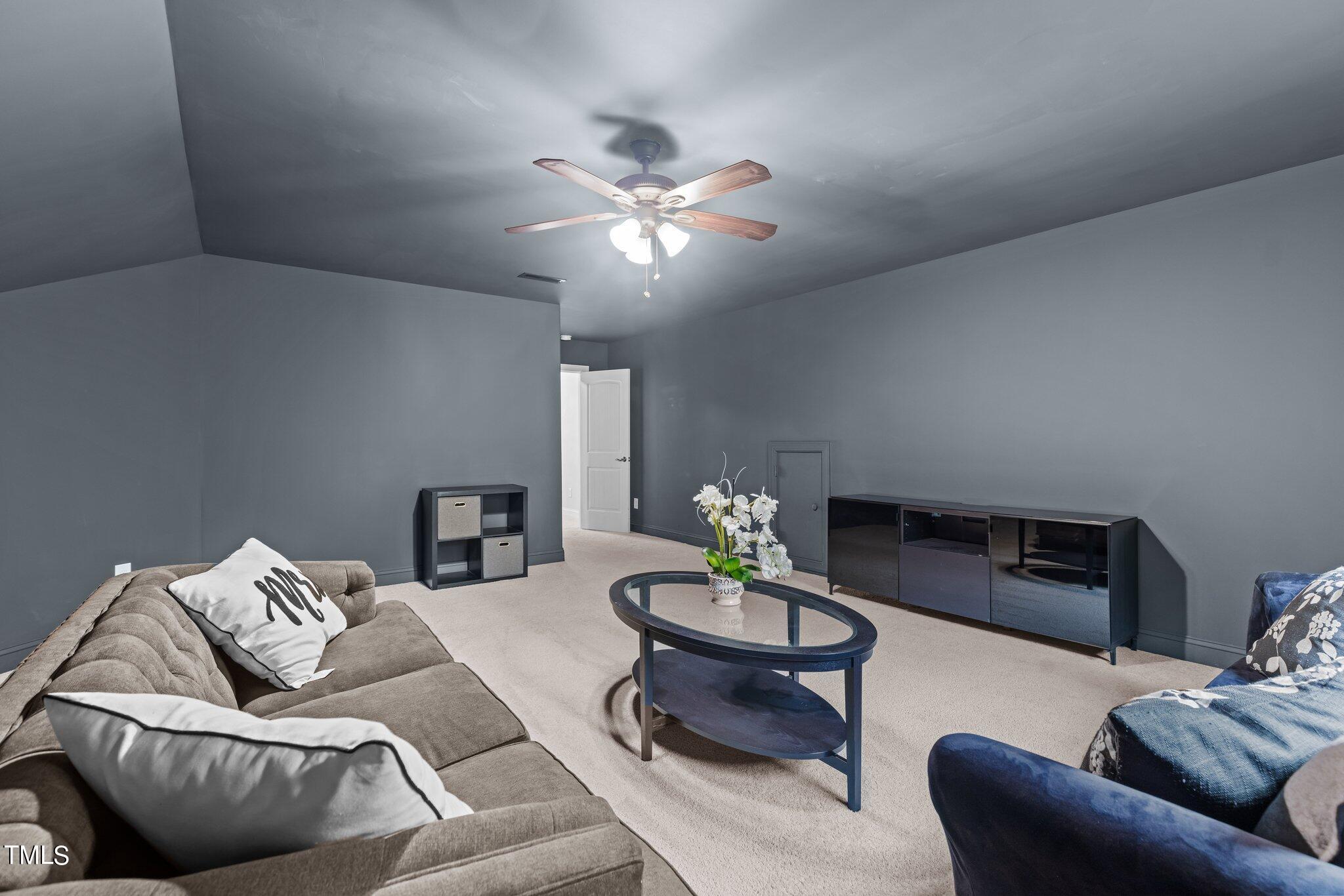417 Bryerstone Drive Willow Spring, NC 27592 - Photo 27 of 43 a living room with furniture and a fireplace