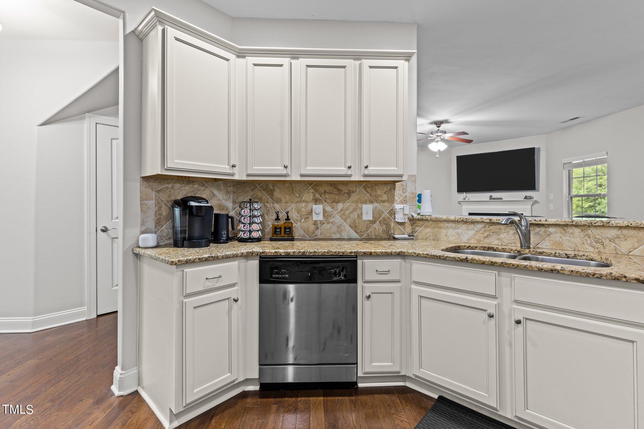 417 Bryerstone Drive Willow Spring, NC 27592 - Photo 7 of 43 a kitchen with granite countertop white cabinets and white appliances
