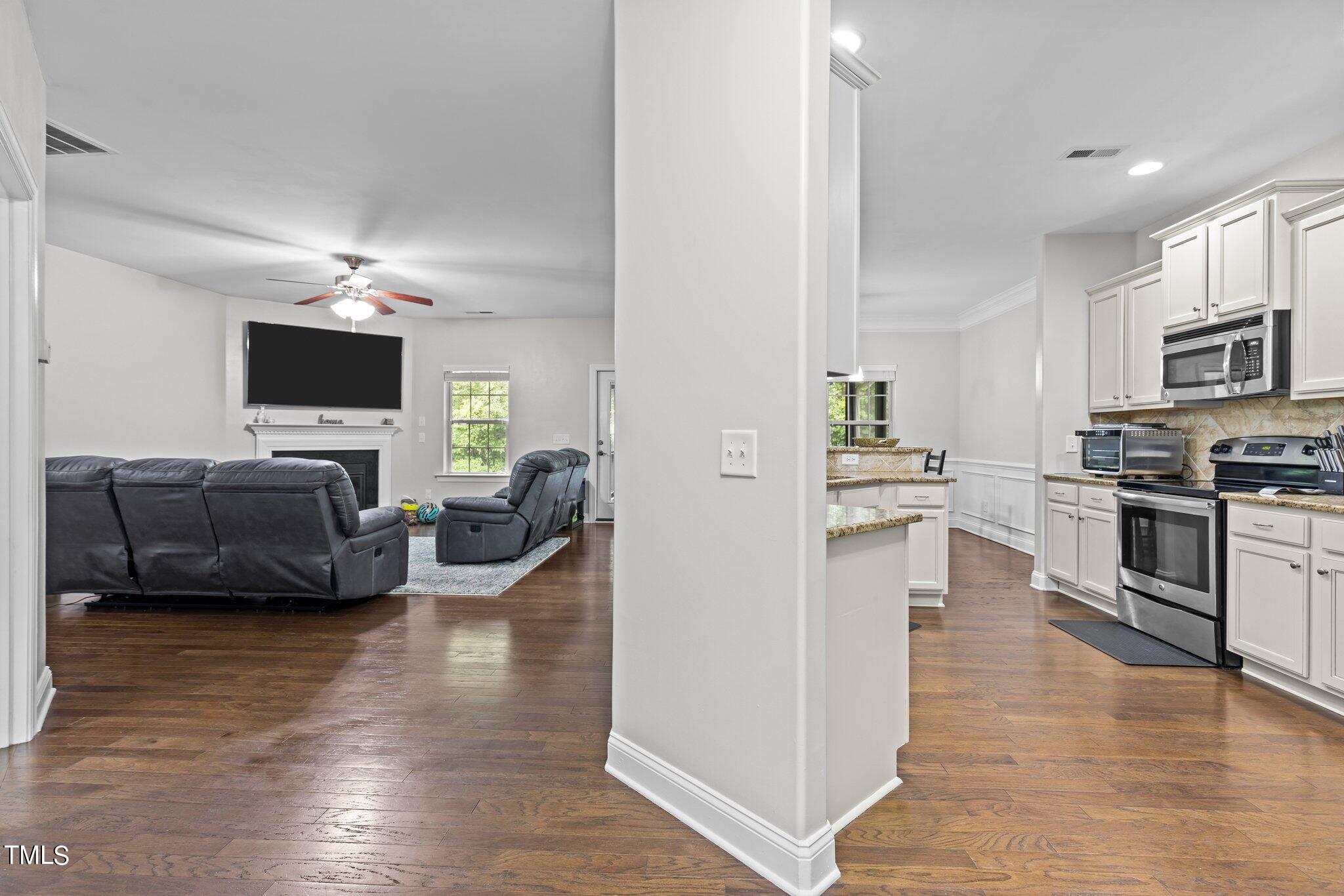 417 Bryerstone Drive Willow Spring, NC 27592 - Photo 9 of 43 a living room with furniture and a flat screen tv