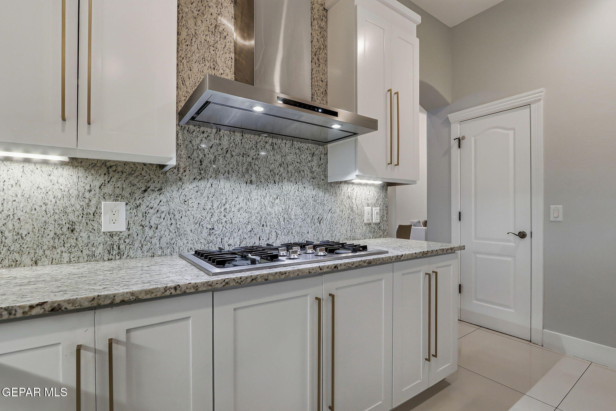 1297 Cypress Ridge Drive El Paso, TX 79912 - Photo 21 of 77 a kitchen with stainless steel appliances granite countertop a sink stove and cabinets