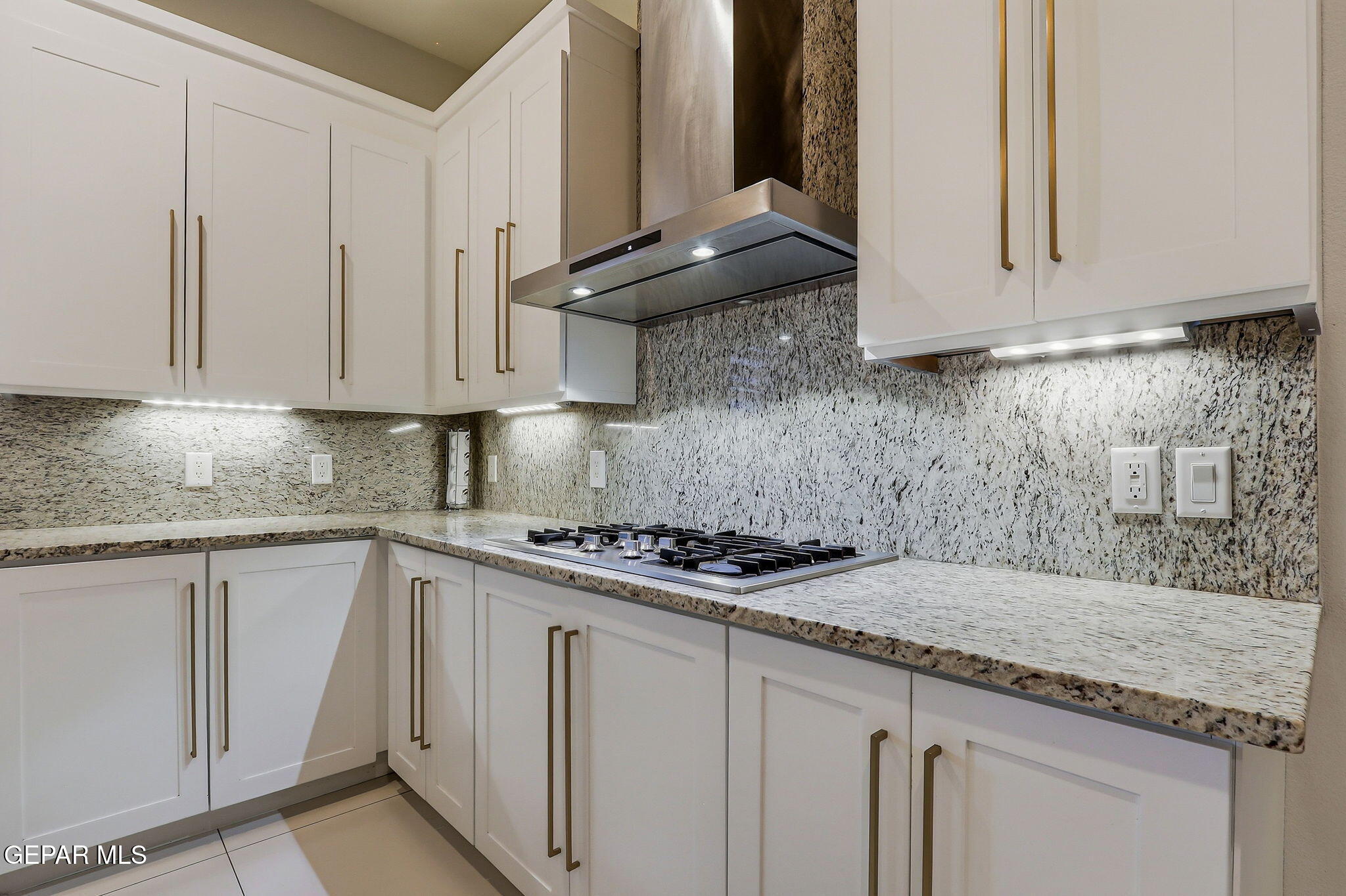 1297 Cypress Ridge Drive El Paso, TX 79912 - Photo 22 of 77 a kitchen with granite countertop white cabinets and a stove