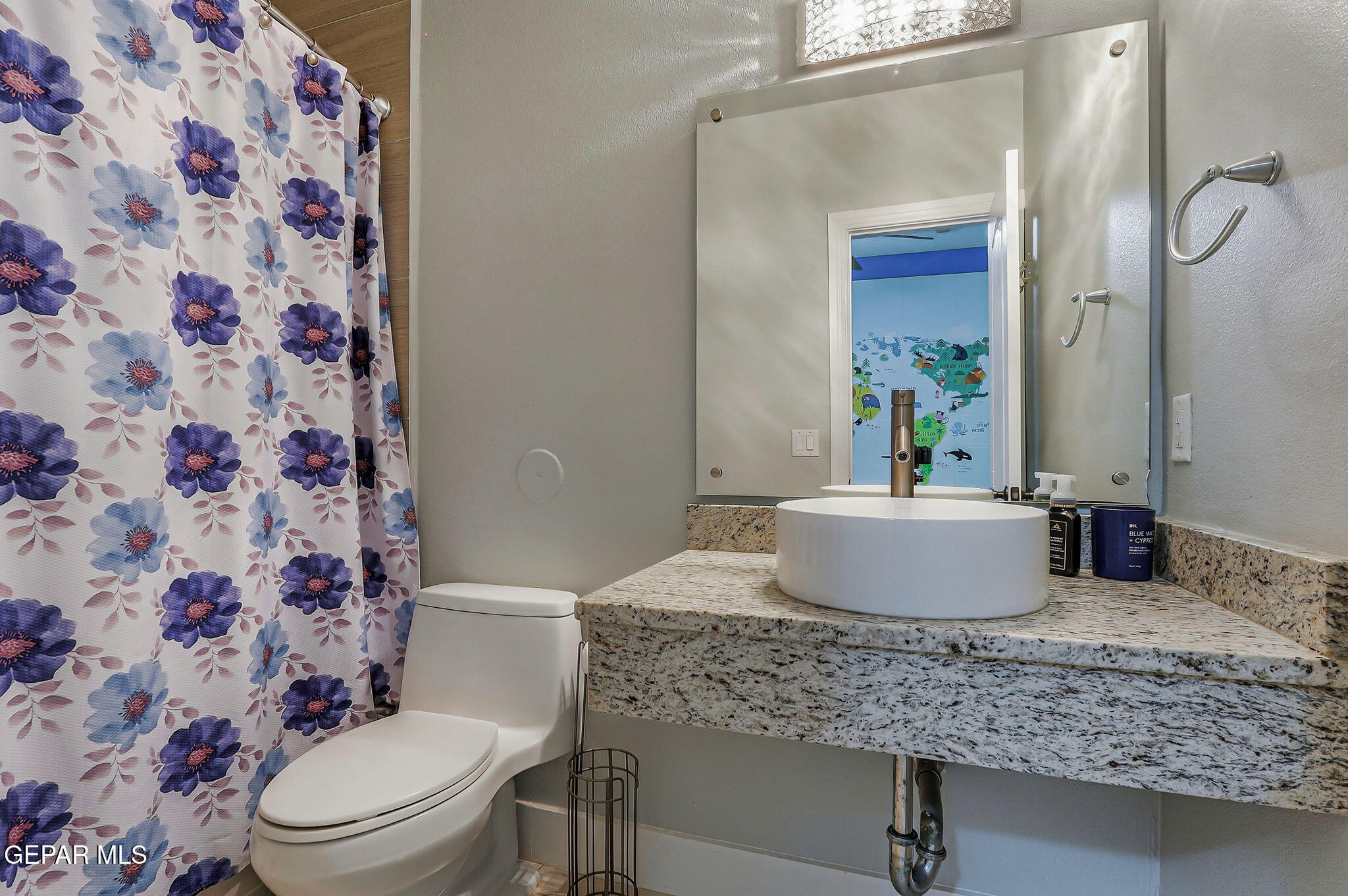 1297 Cypress Ridge Drive El Paso, TX 79912 - Photo 37 of 77 a bathroom with a granite countertop sink toilet a mirror and shower
