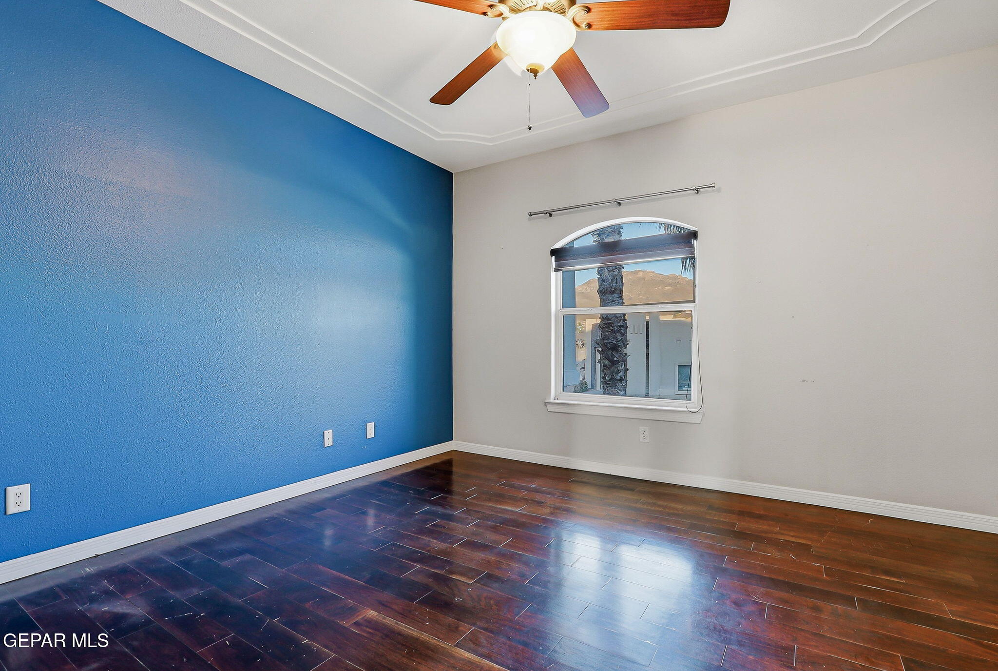 1297 Cypress Ridge Drive El Paso, TX 79912 - Photo 39 of 77 a view of an empty room with wooden floor and a window