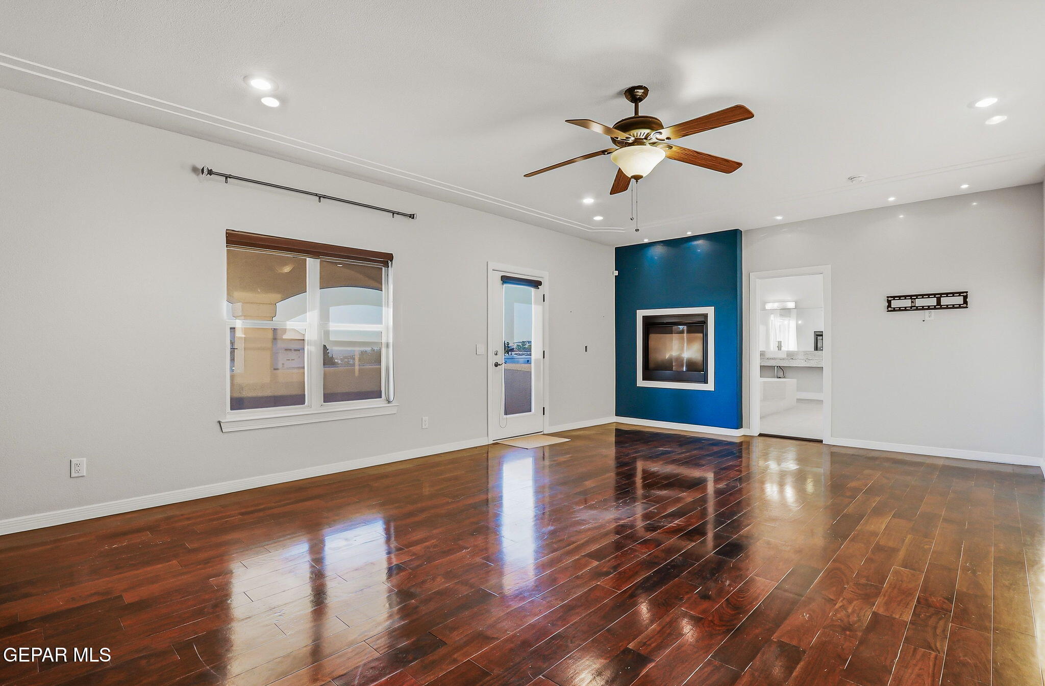 1297 Cypress Ridge Drive El Paso, TX 79912 - Photo 57 of 77 a view of an empty room with window and wooden floor
