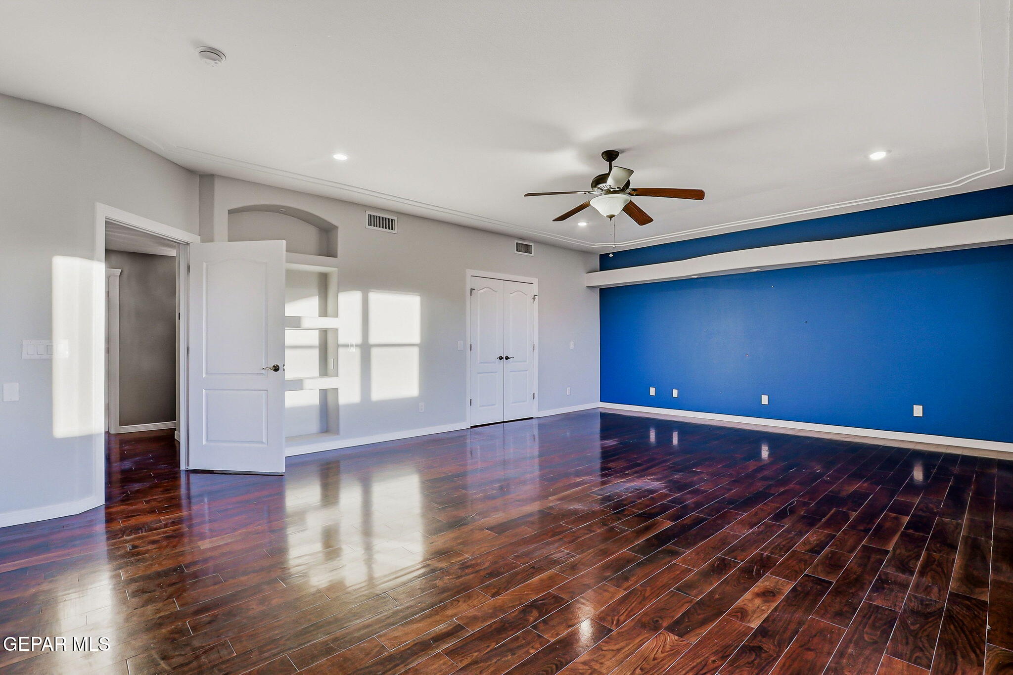 1297 Cypress Ridge Drive El Paso, TX 79912 - Photo 58 of 77 a view of empty room with wooden floor and fan