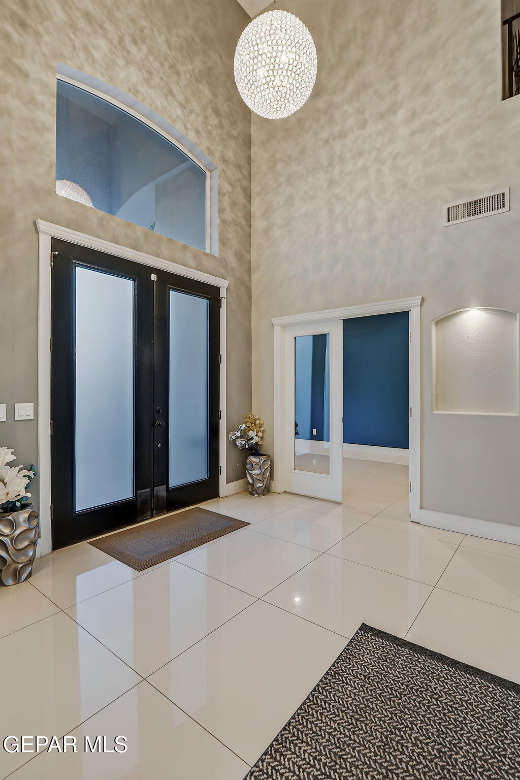 1297 Cypress Ridge Drive El Paso, TX 79912 - Photo 6 of 77 a view of a hallway with wooden floor and chandelier
