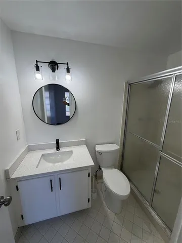 a bathroom with a sink toilet and a mirror