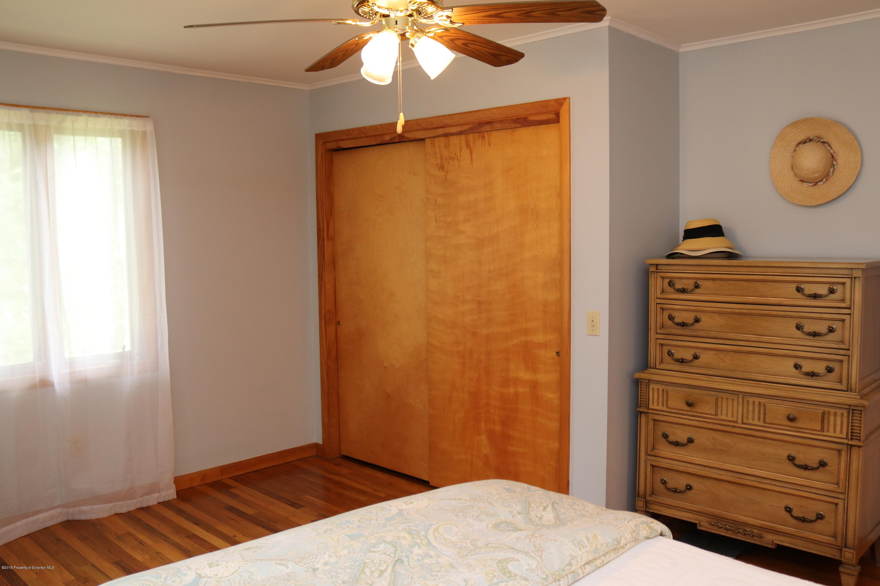 29 Parry Road Moscow, PA 18444 - Photo 18 of 38 a bedroom with a bed and a chandelier