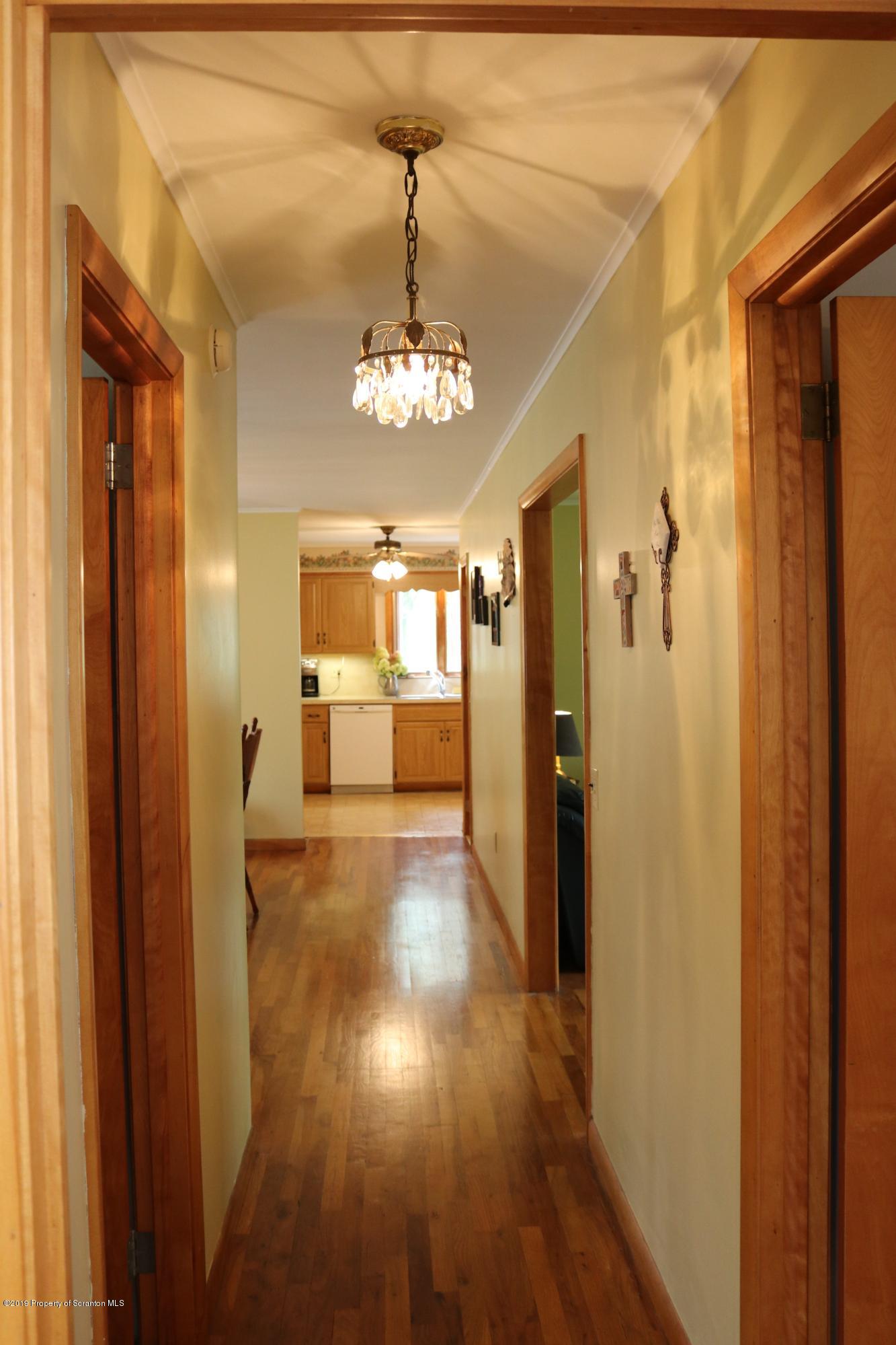 29 Parry Road Moscow, PA 18444 - Photo 19 of 38 a view of a hallway with wooden floor and a kitchen