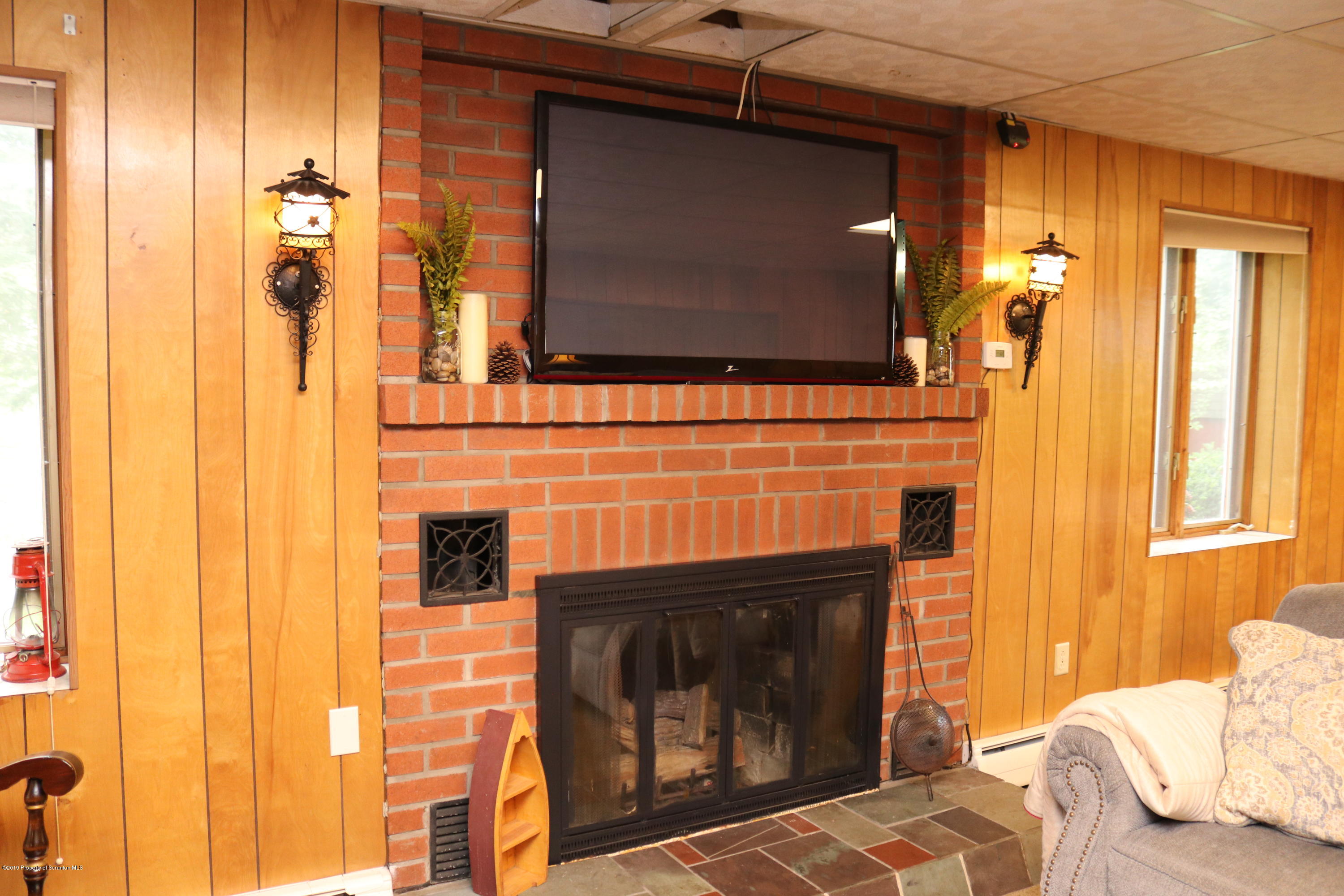 29 Parry Road Moscow, PA 18444 - Photo 21 of 38 a living room with a fireplace and a flat screen tv