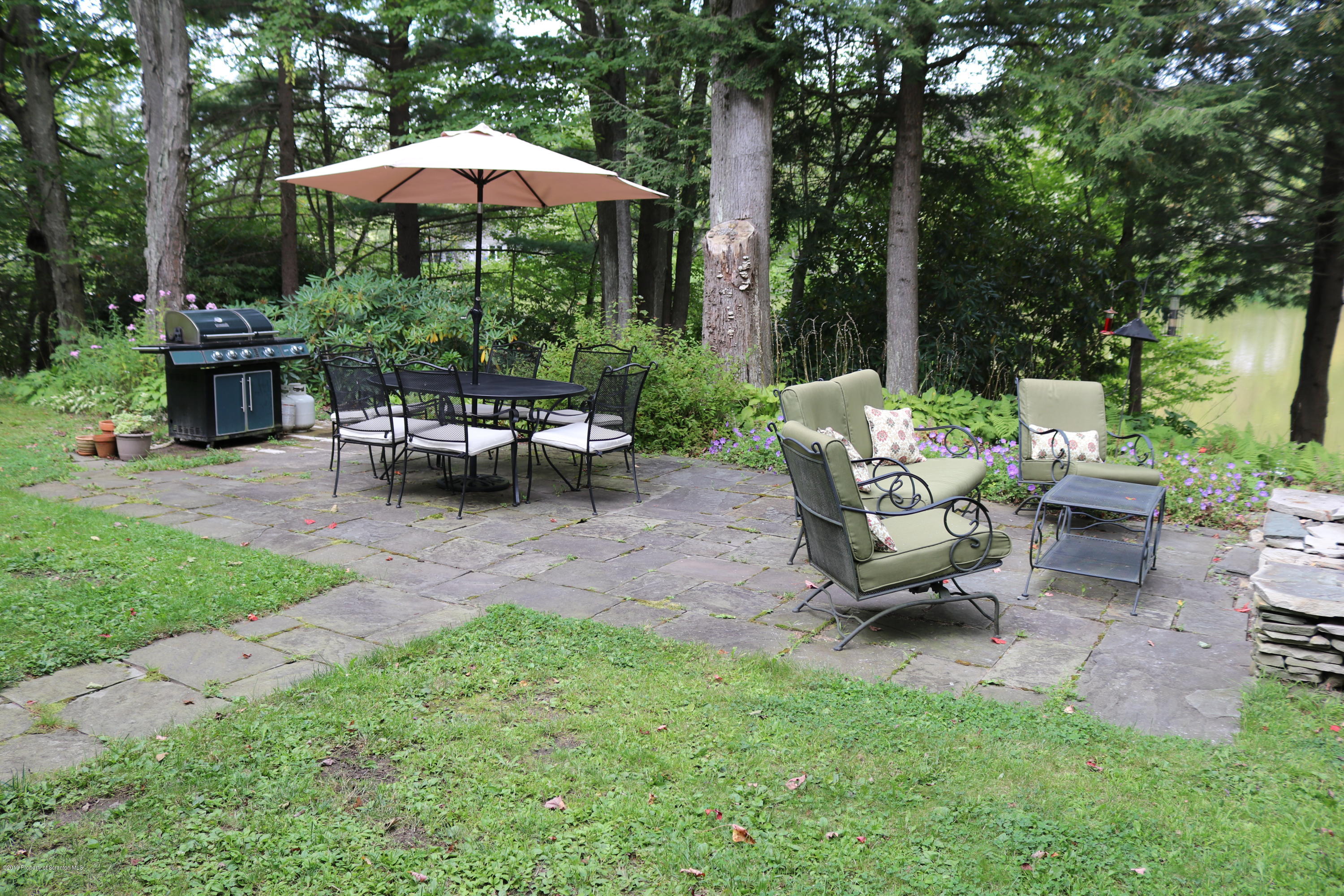 29 Parry Road Moscow, PA 18444 - Photo 33 of 38 a view of a backyard with swimming pool and sitting area