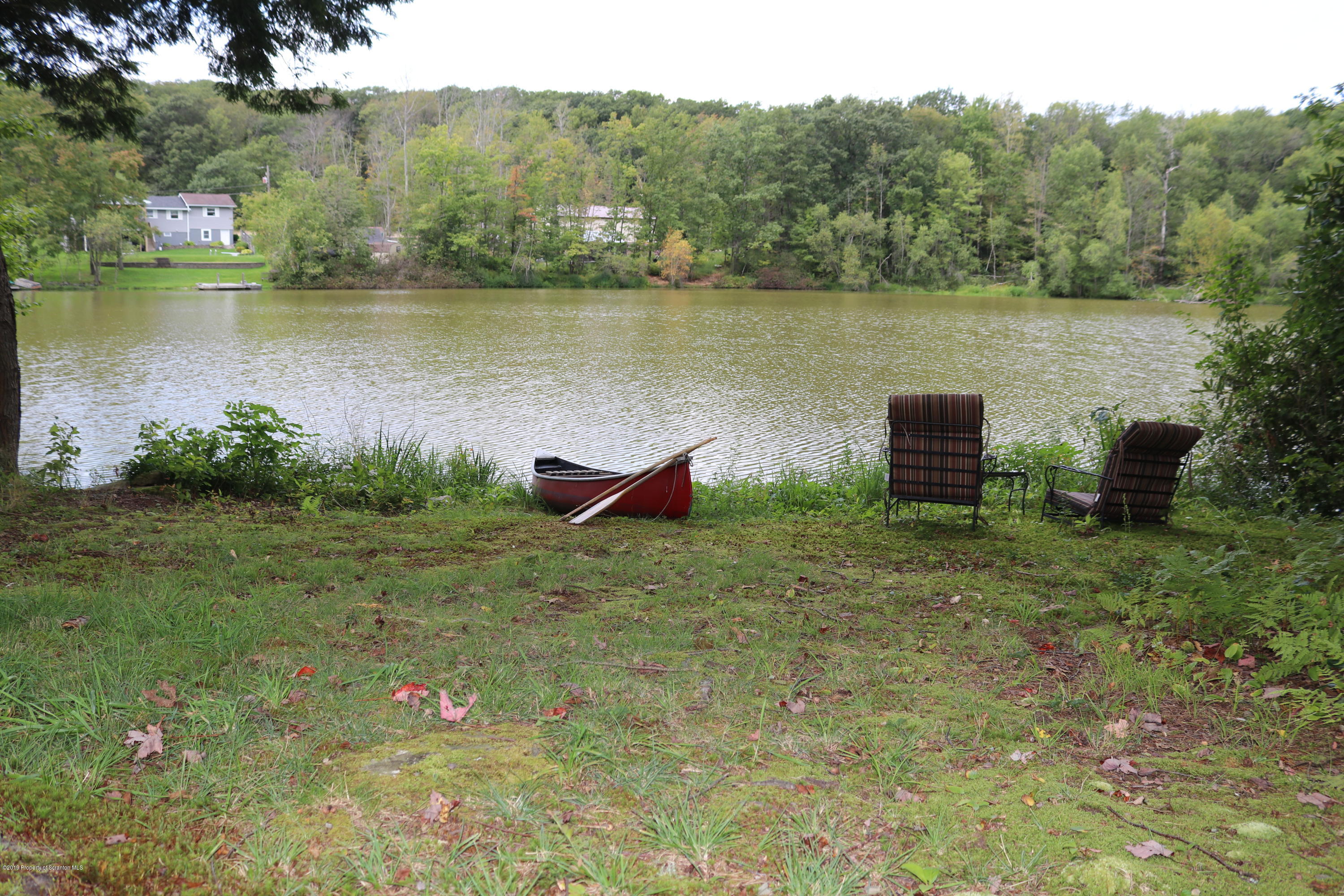 29 Parry Road Moscow, PA 18444 - Photo 34 of 38 a backyard of a house with lots of green space and lake view