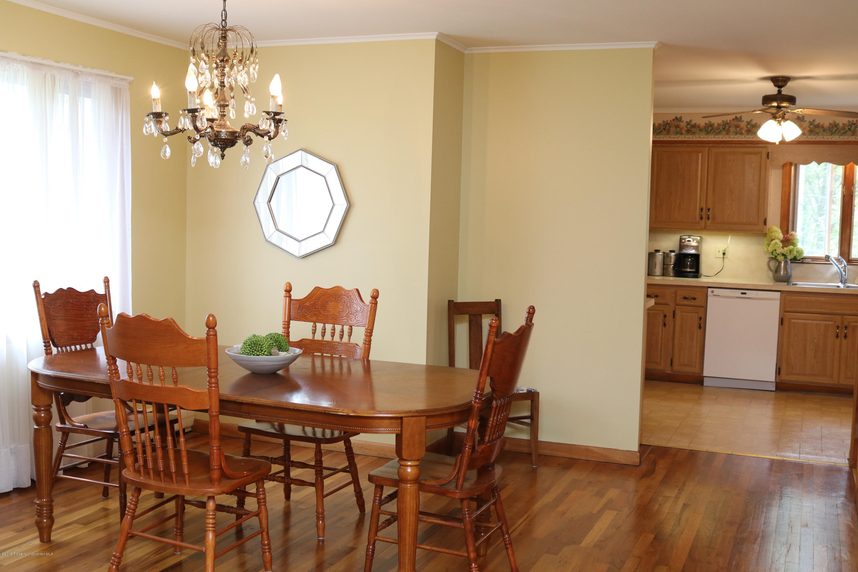 29 Parry Road Moscow, PA 18444 - Photo 5 of 38 a dining room with furniture a chandelier and wooden floor