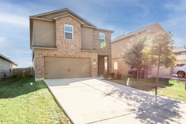 a front view of a house with a yard