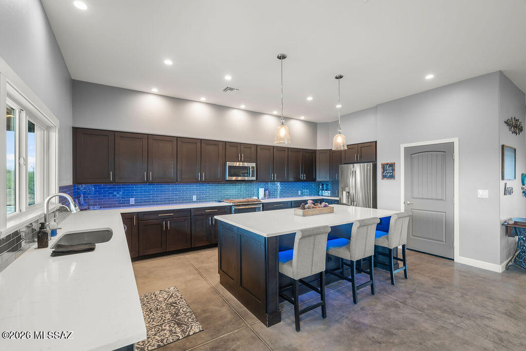16276 East Empire View Road Vail, AZ 85641 - Photo 17 of 51 a kitchen with a sink and chairs