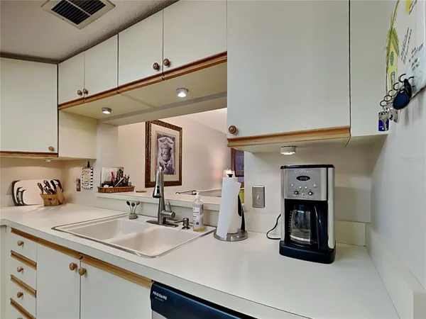 a view of swimming pool that has lawn chairs with plants and lake view