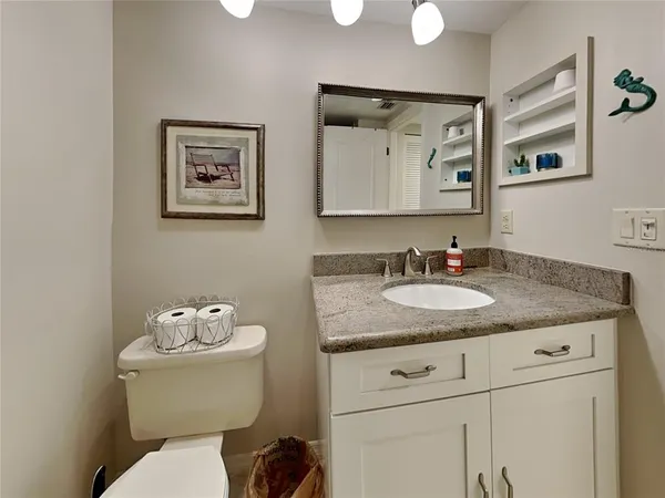 a view of a big dining room with furniture and chandelier