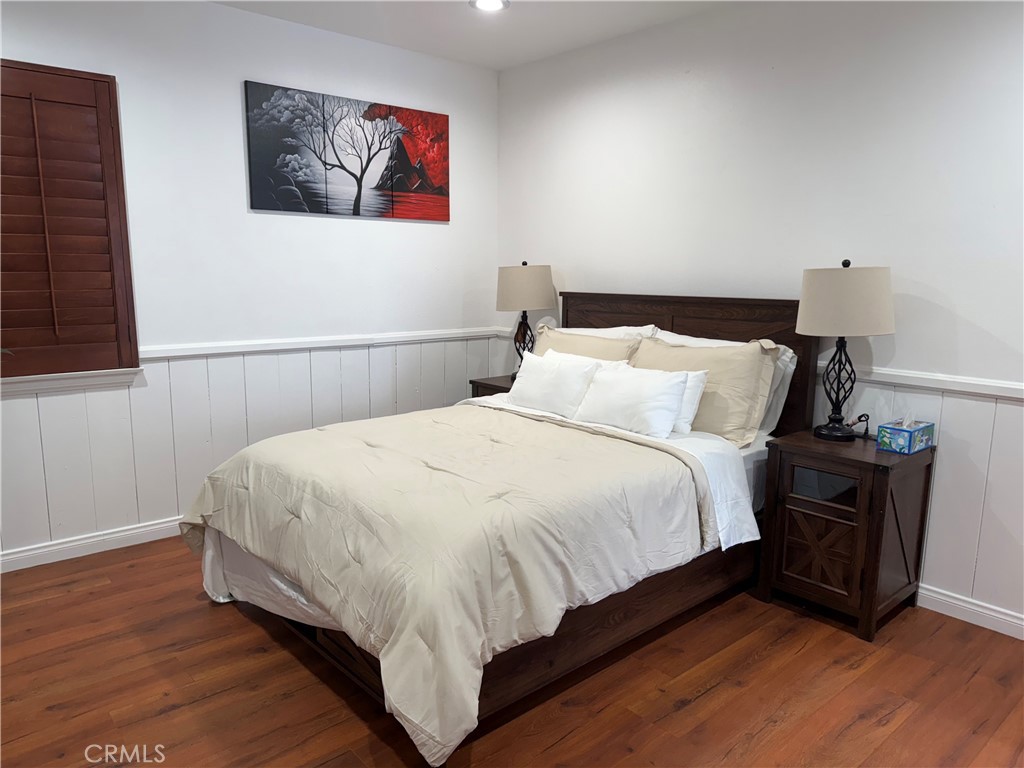 7029 Bellaire Avenue, Unit B North Hollywood, CA 91605 - Photo 1 of 3 a bedroom with bed and wooden floor