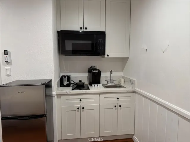 a kitchen with stainless steel appliances a sink a stove a microwave and cabinets