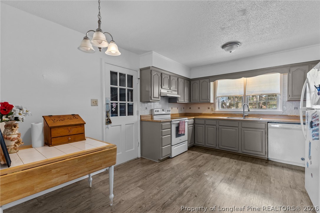 908 Ruton Court Fayetteville, NC 28303 - Photo 11 of 29 a kitchen with a refrigerator and a stove