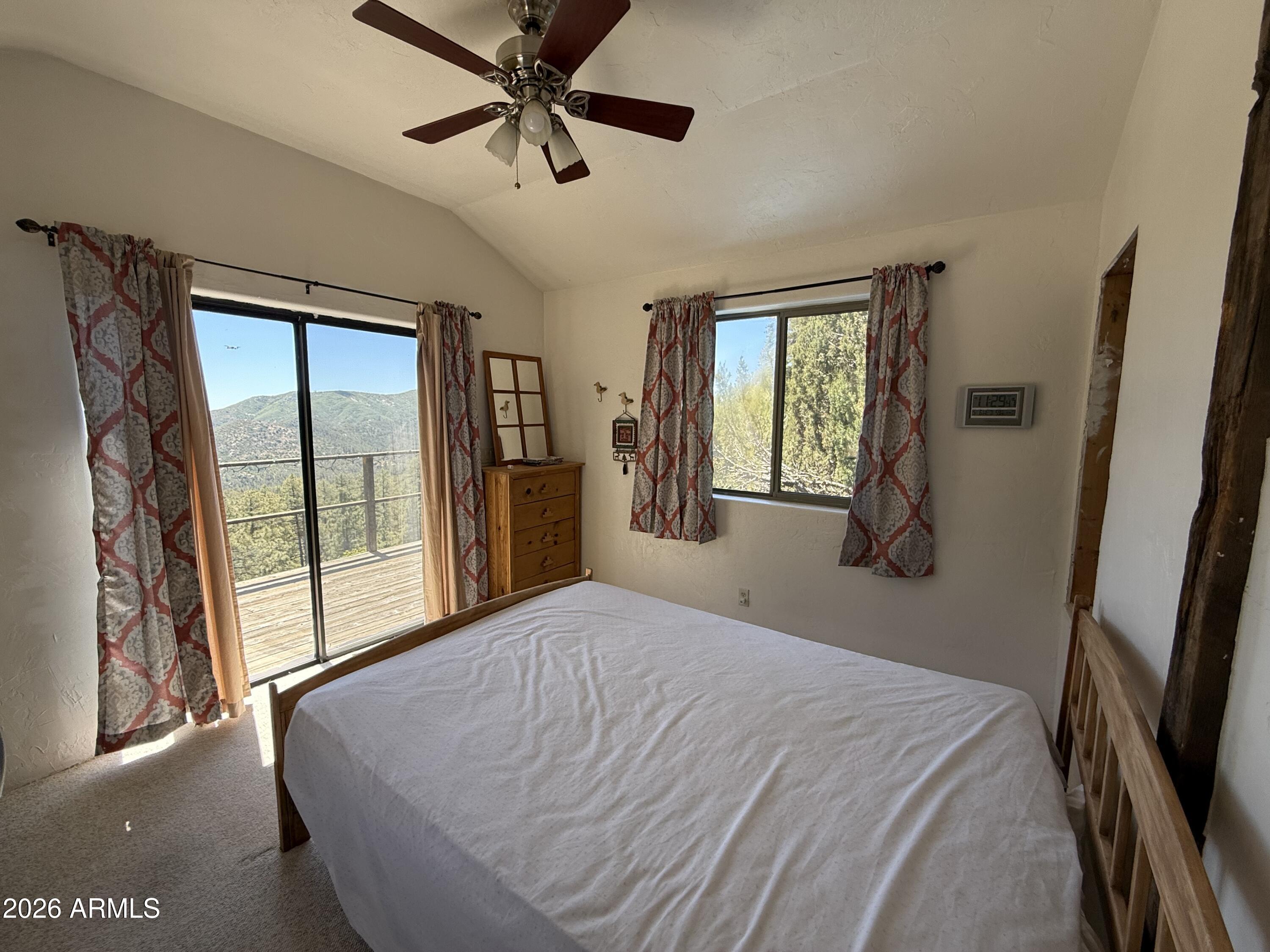 22406 South Eagle Mine Road Crown King, AZ 86343 - Photo 8 of 20 a bedroom with a large bed and a large window