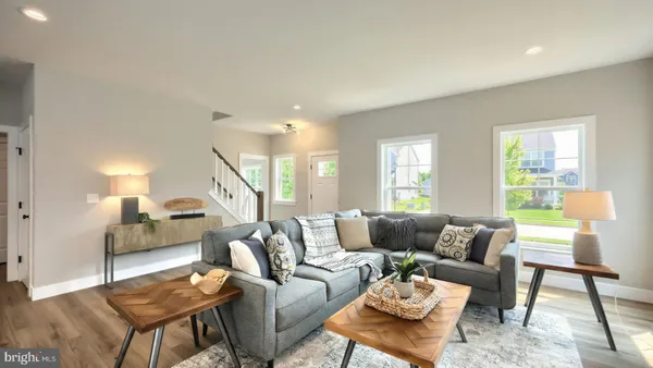 a living room with furniture and a wooden floor