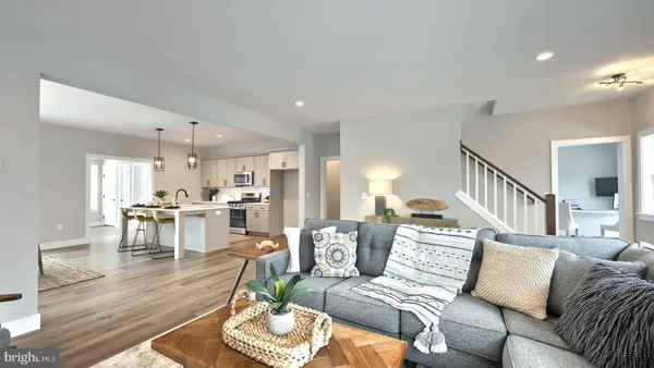 a living room with furniture kitchen view and a dining table
