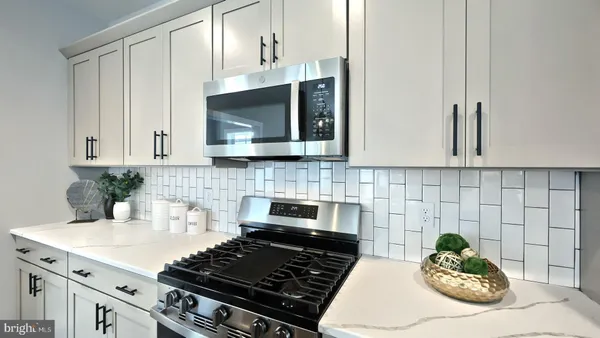 a kitchen with a stove and cabinets