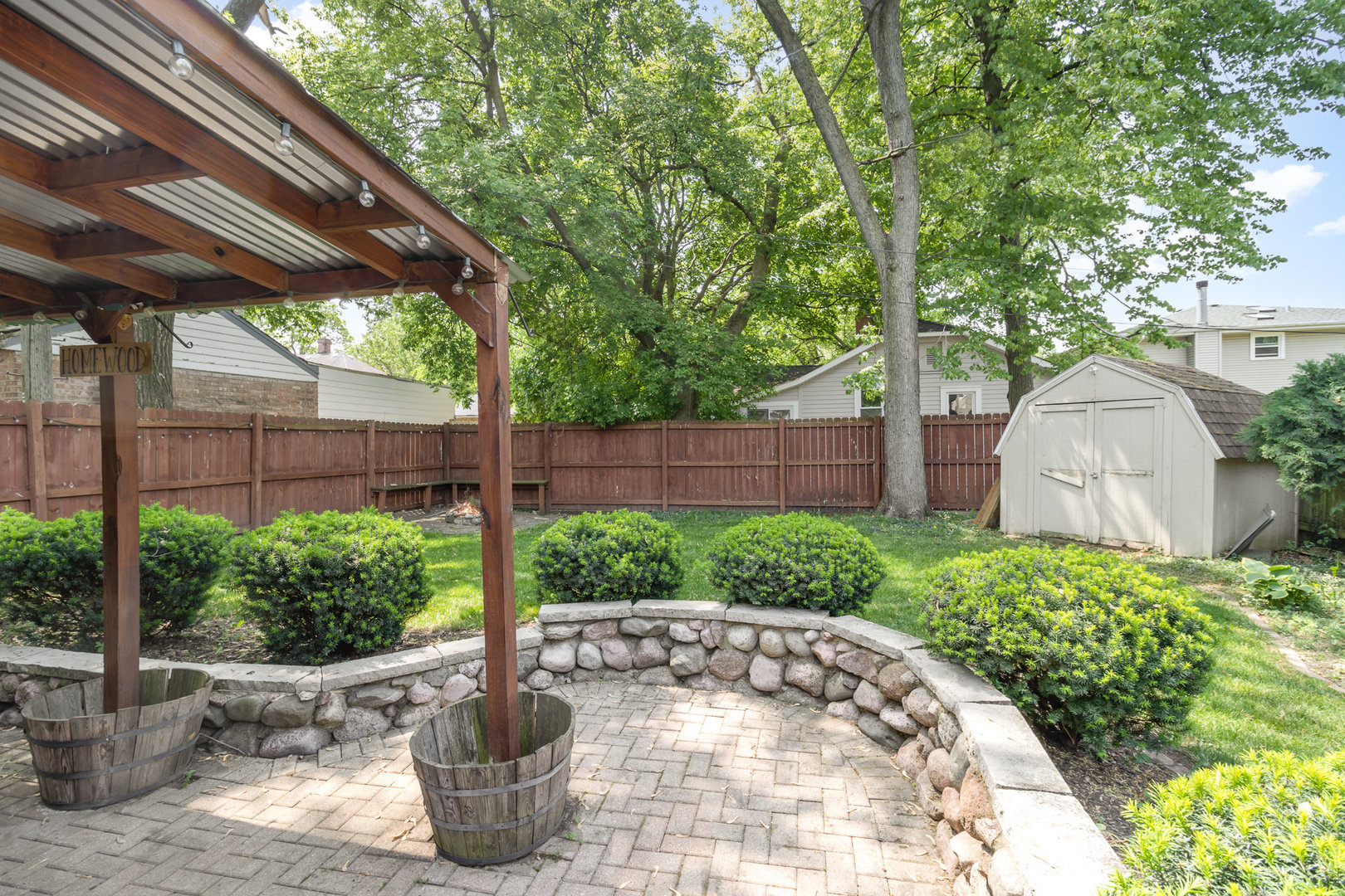 2121 Pine Road Homewood, IL 60430 - Photo 13 of 20 a view of a backyard with potted plants and a fountain