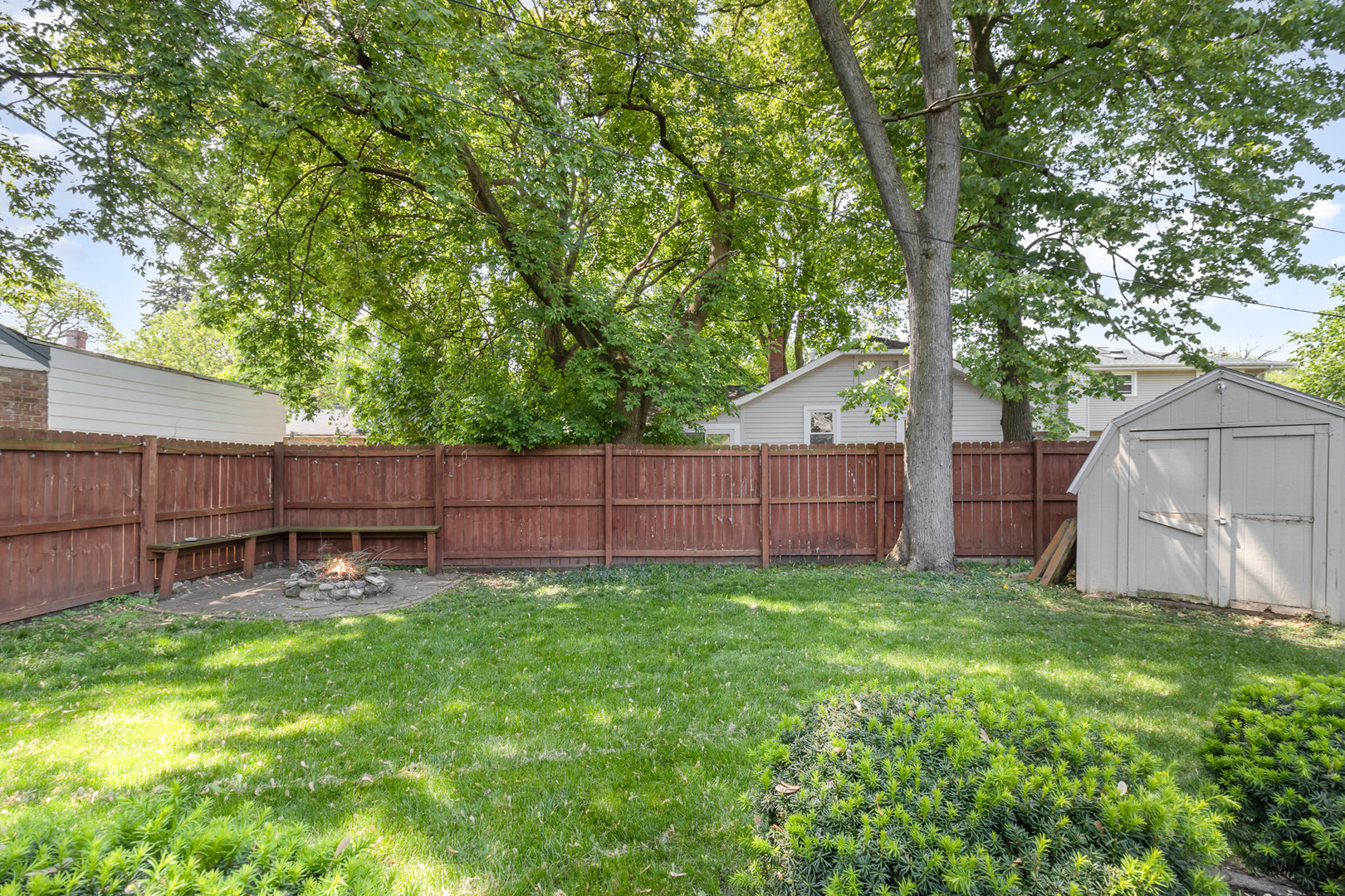 2121 Pine Road Homewood, IL 60430 - Photo 17 of 20 a view of a backyard with a small cabin and a chair
