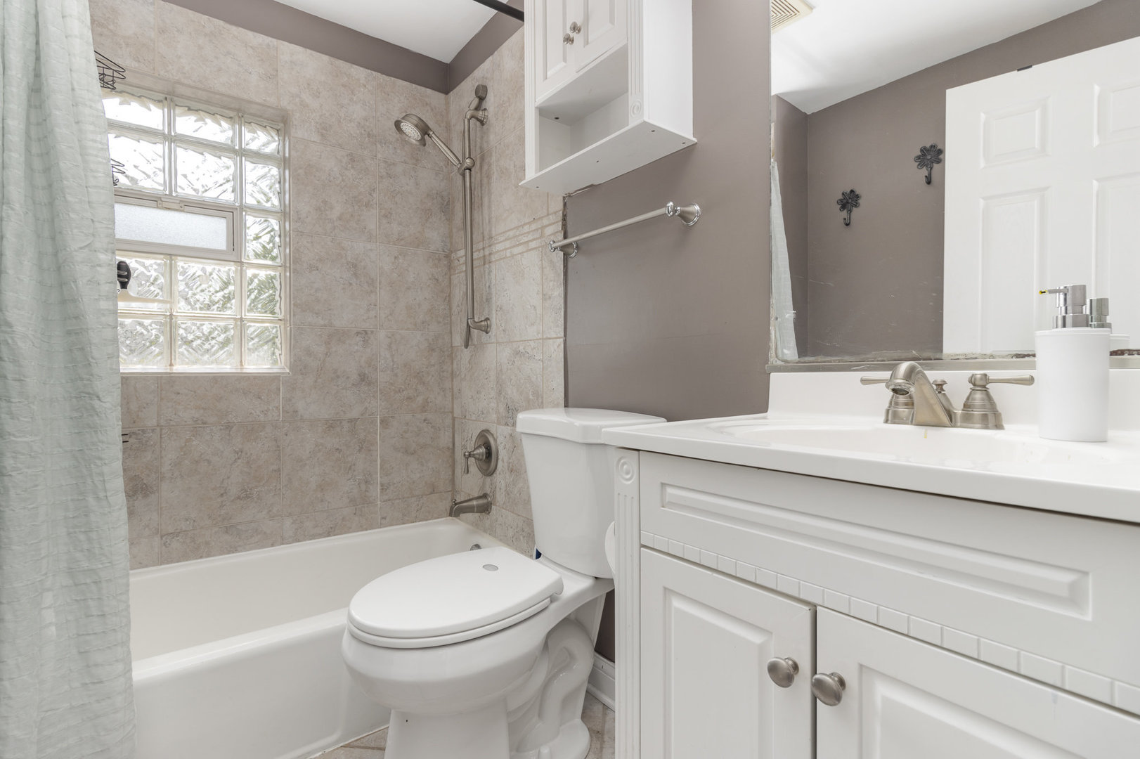 2121 Pine Road Homewood, IL 60430 - Photo 9 of 20 a bathroom with a sink a toilet and shower