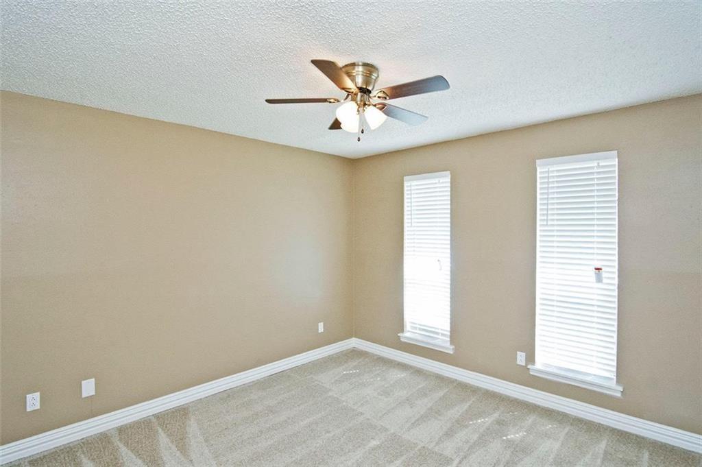 2509 Country Valley Road Garland, TX 75041 - Photo 11 of 17 Empty room with light carpet, a ceiling fan, and a textured ceiling