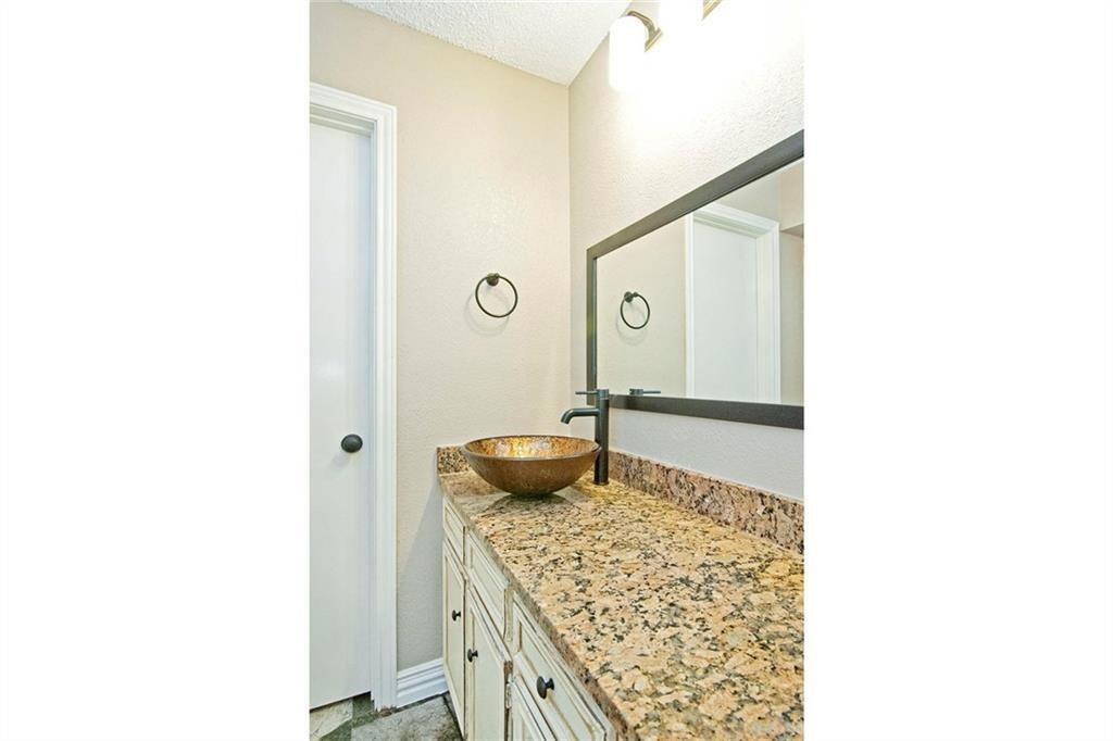 2509 Country Valley Road Garland, TX 75041 - Photo 12 of 17 Bathroom with vanity and a textured ceiling