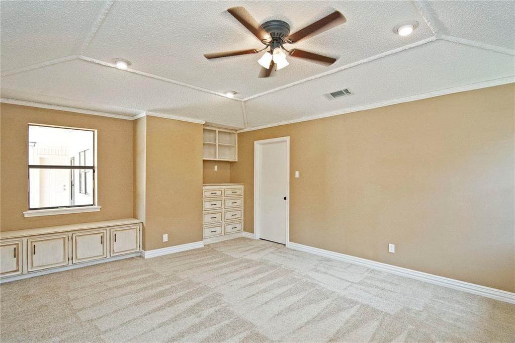 2509 Country Valley Road Garland, TX 75041 - Photo 15 of 17 Spare room featuring light colored carpet, a textured ceiling, crown molding, and ceiling fan