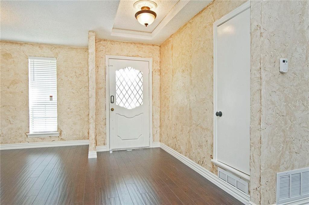 2509 Country Valley Road Garland, TX 75041 - Photo 3 of 17 Entrance foyer with a tray ceiling and dark wood-type flooring