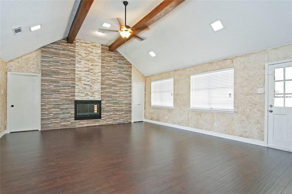 2509 Country Valley Road Garland, TX 75041 - Photo 6 of 17 Unfurnished living room with a ceiling fan, a fireplace, and dark wood-type flooring